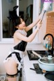 A woman in a bunny costume cleaning a kitchen counter.