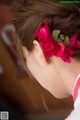 A woman with a flower in her hair. 