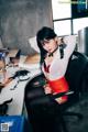 A woman sitting at a desk in an office.